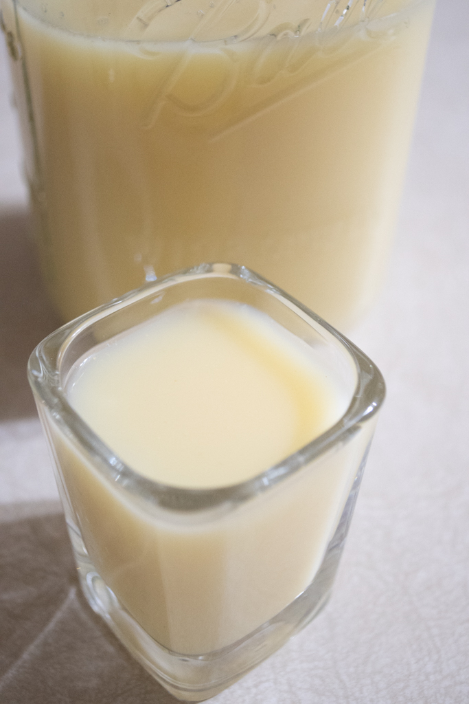 Shot glass with light yellow liquid